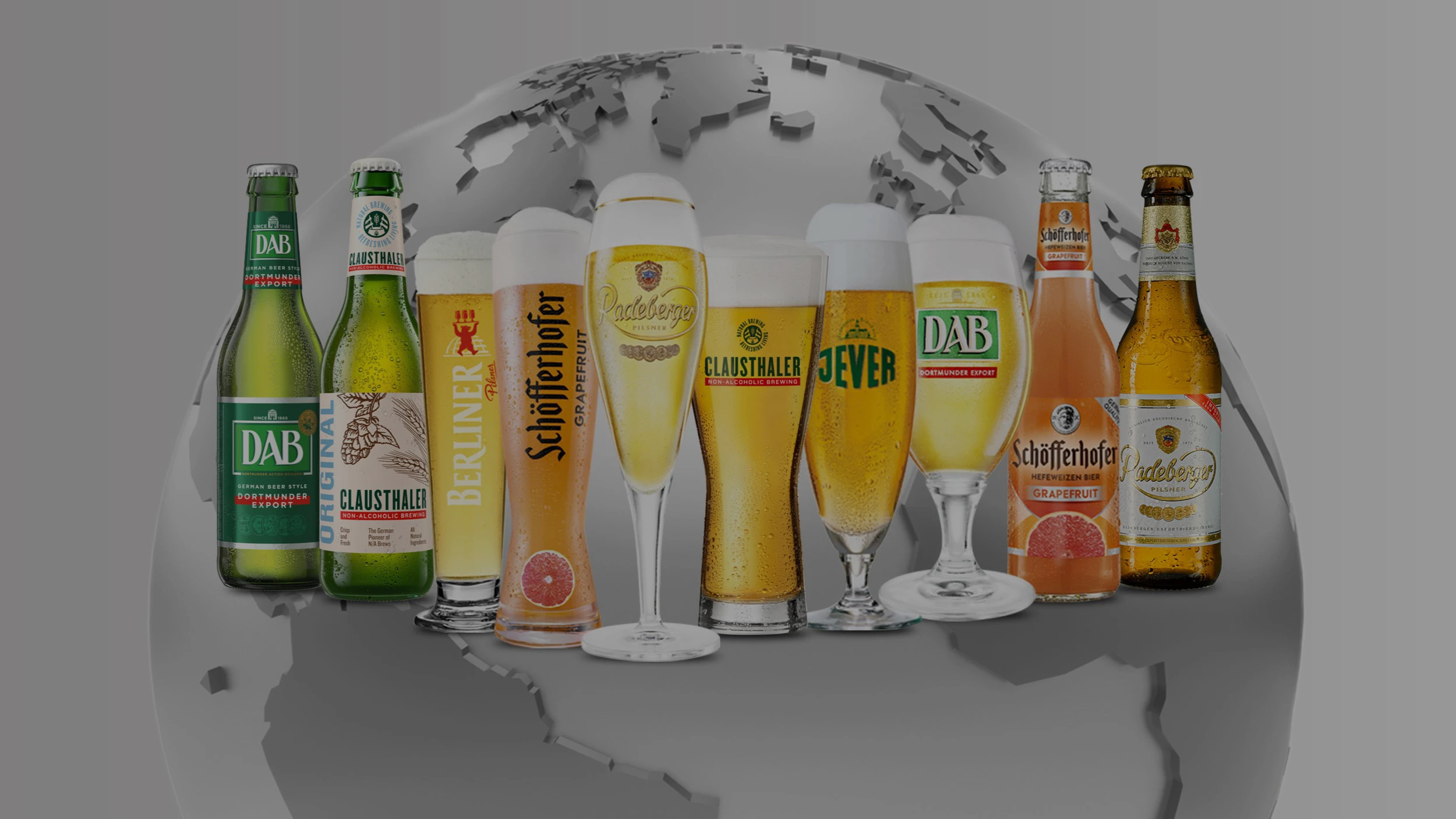 Several bottles and glasses of beer are displayed in front of a stylized globe.